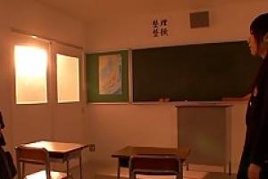 Two Asian schoolgirls are cuddling each other   s nice tits  while in front of the black board