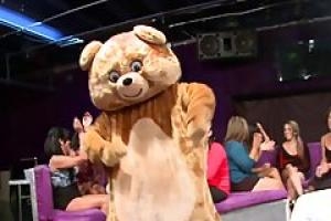 A very handsome guy dressed up as a bear is dancing for naughty ladies and fucking them
